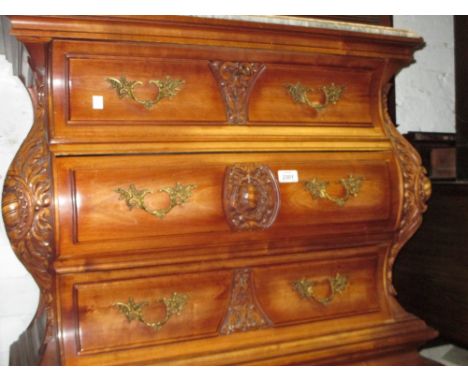 Small Spanish grey and white flecked marble topped three drawer commode with carved decoration