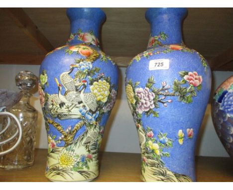 Pair of 20th Century Chinese baluster form vases decorated with birds and flowers in relief on a pale blue ground, impressed 