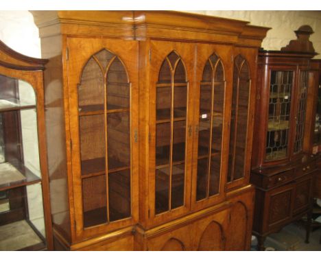 Good quality 20th Century burr walnut breakfront bookcase having moulded cornice above four bar glazed doors with Gothic arch