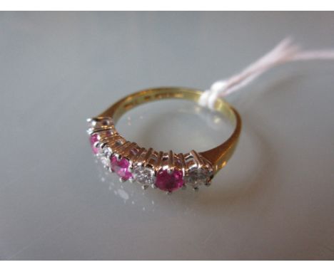 Seven stone ruby and diamond set ring