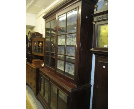 Mid 18th Century mahogany bookcase with moulded cornice above a pair of bar glazed doors, the base with a further pair of bar