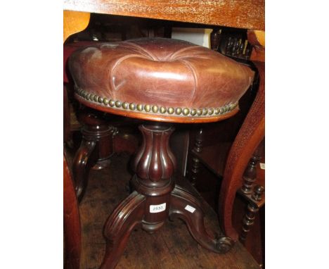 Victorian rosewood piano stool with buttoned leather upholstered swivel seat on a tripod base