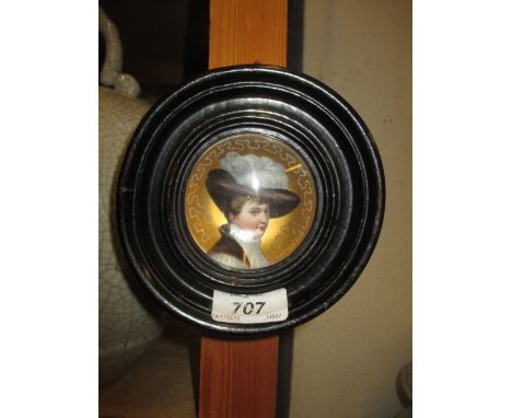 Small Continental porcelain concave plaque painted with a portrait of a lady wearing a feathered hat in a circular ebonised f
