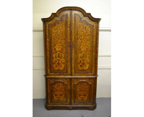 18th Century Dutch walnut and marquetry inlaid corner cabinet, the shaped moulded cornice above two pairs of panelled doors, 