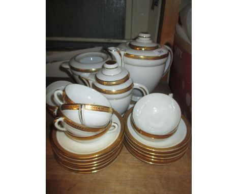 Late 19th Century porcelain teaset comprising: teapot, milk jug, sugar bowl and ten cups with saucers, all with gilt rims and