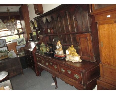 18th Century oak three drawer dresser base raised on cabriole claw supports with a later associated boarded shelf back