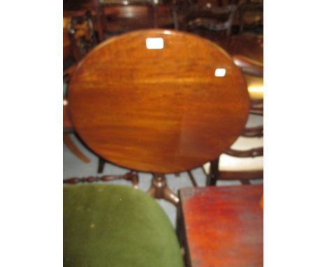 George III mahogany circular tilt top pedestal table with a turned column support and tripod base