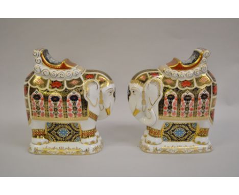 Pair of Royal Crown Derby figures of elephants decorated in Imari colours with gilt button inserts to the base, 8.25ins high