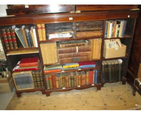 Mahogany breakfront open bookcase with a moulded cornice above adjustable shelves raised on bracket feet, circa 1900
