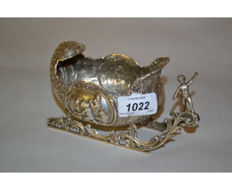 19th Century Dutch silver model of a shell form sled with all-over embossed decoration and putto figure head