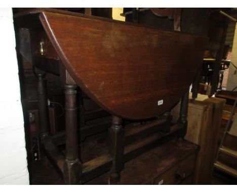 18th Century oak gate leg table, the plank top above two end drawers on baluster turned supports with stretchers