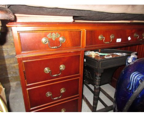 Reproduction mahogany twin pedestal desk having green leather inset top above nine drawers on bracket feet