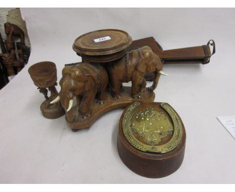 Carved wooden vase stand in the form of three elephants, brass mounted oak cribbage board in the form of a horseshoe, pair of