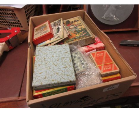 Box containing a quantity of playing cards and childrens games