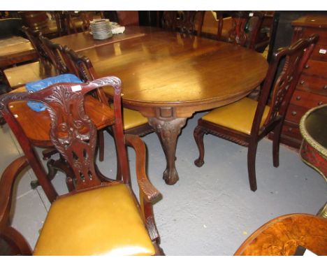 Mahogany dining room suite in Chippendale style, the oval extending table raised on carved cabriole claw and ball supports wi