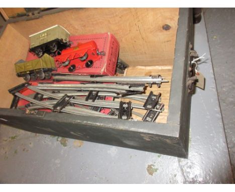 Quantity of Hornby 0 gauge rolling stock and track housed in a painted wooden trunk