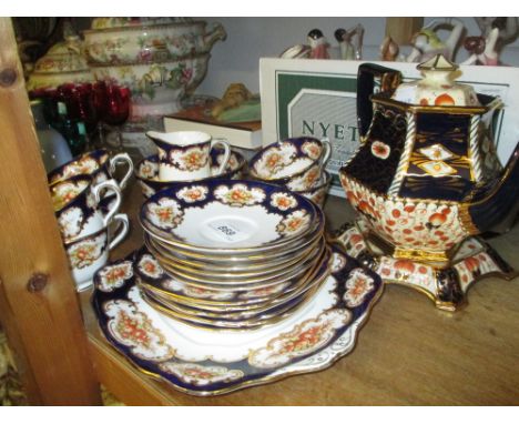 Royal Albert Imari pattern teaset comprising: six cups and saucers, cake plate, sugar bowl and cream jug and teapot with stan