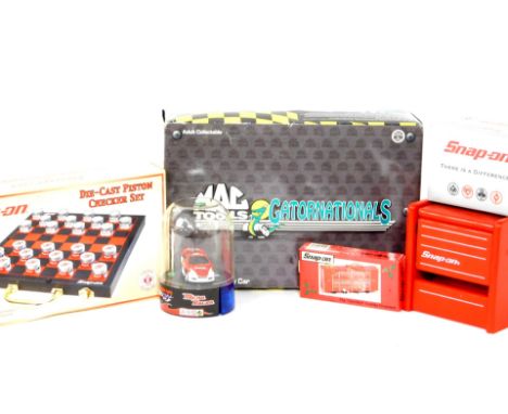 A Snap-On die cast piston chequer set, Snap-On 'The Tool Wall' holiday ornament, Snap-On playing cards, MacTools Gatornationa