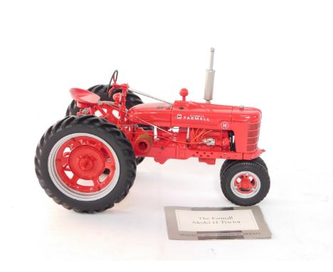 A Franklin Mint Precision Models die cast Farmall Model H tractor, 1:12 scale, red, with certificate of authenticity.