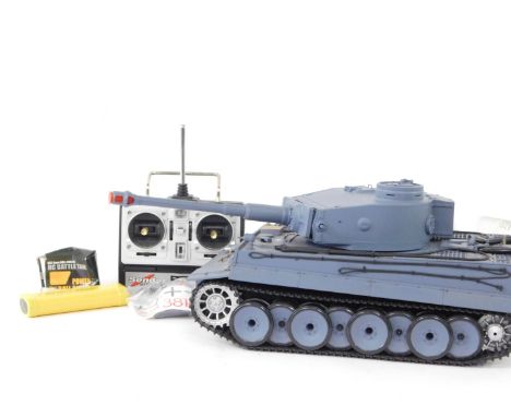 A radio controlled battle tank, modelled as a German Tiger 1 tank, 1:16 scale, with Sender radio control, and accessories.