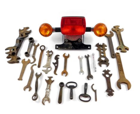 A 2006 Royal Enfield tail light cluster, together with assorted vintage spanners. (qty)