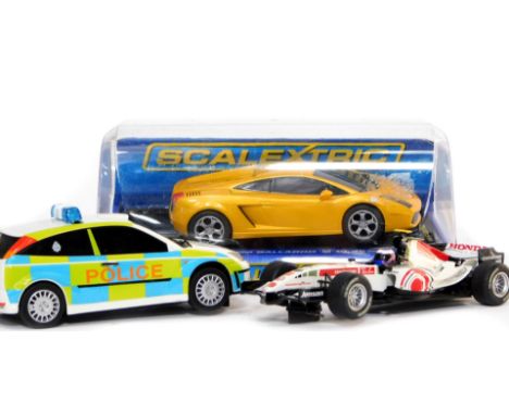 Three Scalextric model cars, comprising Lamborghini Gallardo, Honda Racing F1 car, and Ford Focus WRC police car.