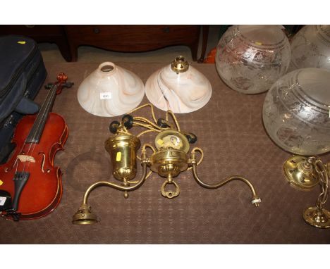 A brass rise and fall twin branch ceiling light with shades