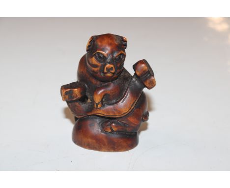 A Japanese carved wooden Netsuke in the form of a pig 