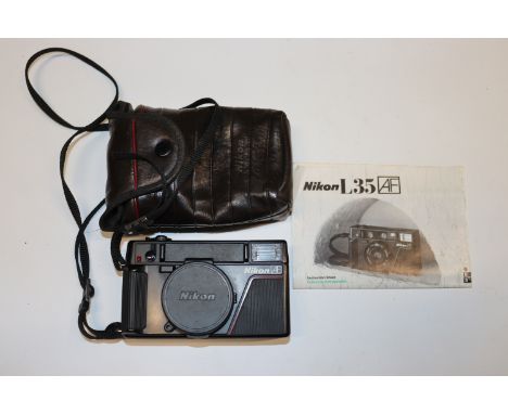 A Nikon L35AF 35mm camera with case and manual
