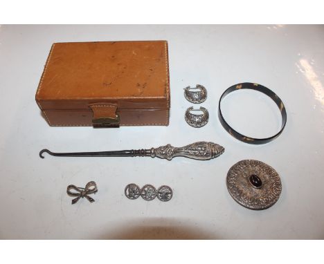 A small case containing silver handled button hook, ear-rings and brooches