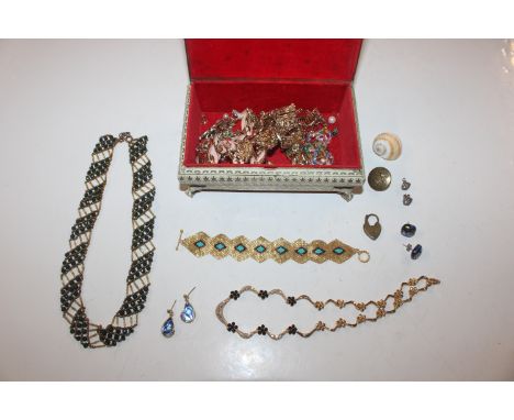 A trinket box and contents of costume jewellery 