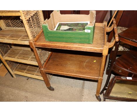 A mid-20th Century light oak two tier tea trolley