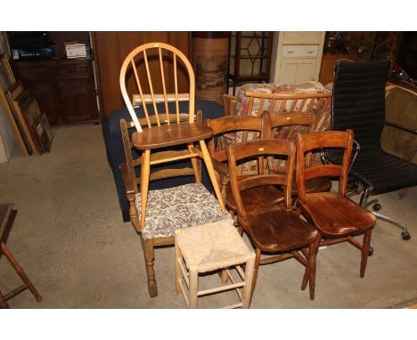 Four bar back elm seated chairs; an Ercol stick back chair; a ladder back elbow chair and a rush seated stool