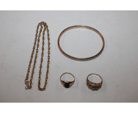 A 9ct gold bangle, approx. 6.5gms; a 9ct gold ring, approx. 3.5gms, ring size L/M; a 9ct gold ring set with black stone, appr