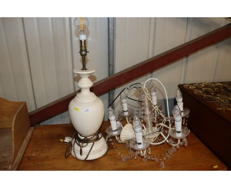 A cream painted baluster table lamp; and a six light prism drop chandelier