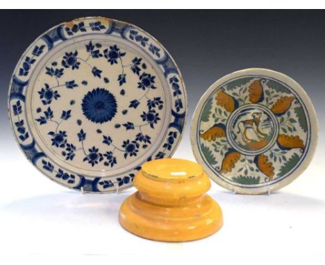 17th Century Continental pottery dish (rebuilt), decorated with a dog and a foliate border, 25cm diameter, together with an 1