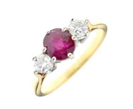 Ruby and diamond three stone ring, unmarked, the oval cut with brilliant cut diamonds to either side, totalling approximately