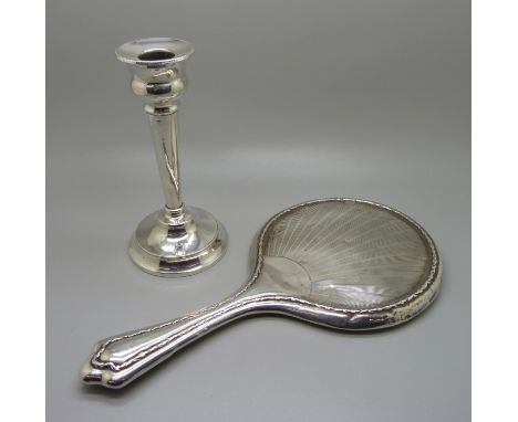 A silver candlestick and a hand mirror 