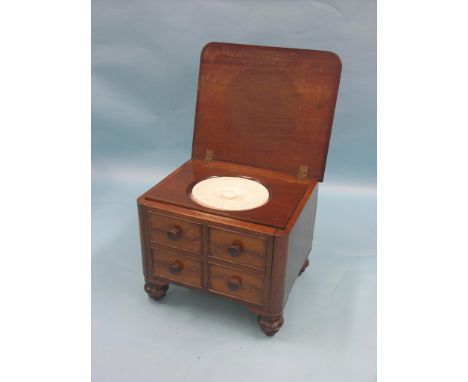 A Victorian mahogany commode, mock drawer-fronts with turned wood knob handles, cupboard with ceramic pot enclosed, on turned