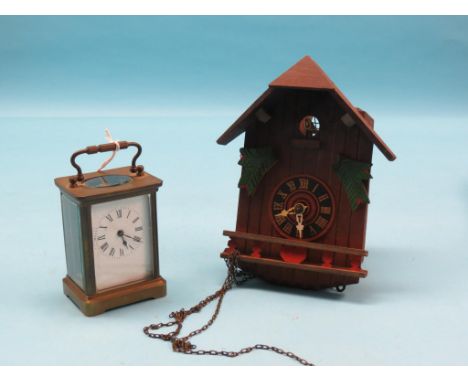 An early 20th century French carriage clock, enamelled dial and timepiece movement, together with a painted wood cuckoo clock