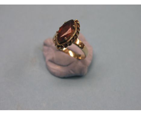 An 18ct. gold ring, set faceted oval ruby, size P