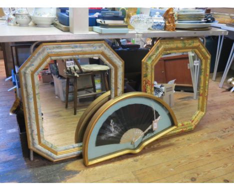 A mother of pearl fan, with painted detail, in moulded gilt frame, 26in. wide, and a pair of octagonal mirrors, with colour-p