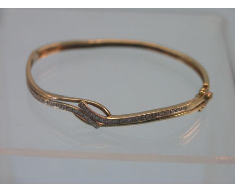 A 9ct. gold and diamond bangle, set numerous diamond chips, 7.5 grams gross total