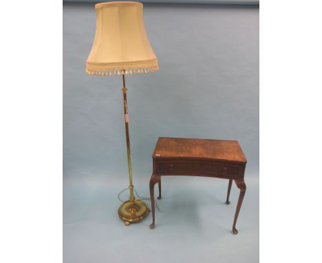 An early 20th century brass floor-lamp, with green shade, together with a burr walnut side table with single drawer, as viewe