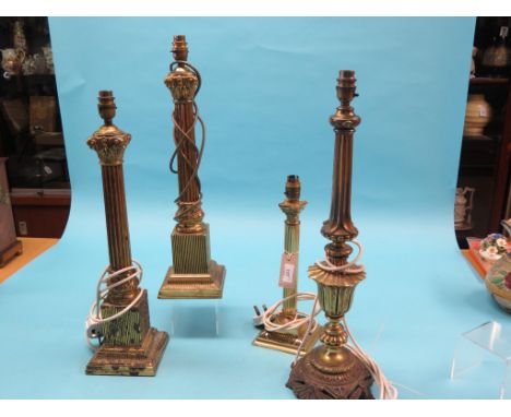 A pair of brass Corinthian column table lamps, 20in., another, similar, 12.5in., and one other brass table lamp