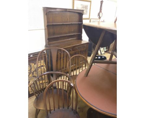 A matched dining room set, elm drop-leaf table, panelled oak dresser with plate-rack, 4ft., and five stick-back chairs includ