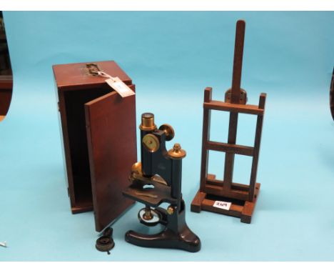 A microscope, R & J Beck Ltd., with rotating twin-objectives, in original mahogany case with lens accessories, together with 