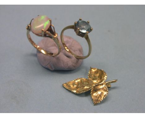 A 9ct. gold dress ring, set single large opal, together with a 9ct. gold ring set single blue stone and a yellow metal clover