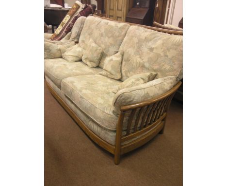 A modern Ercol Golden Dawn three-piece suite, ash stick-back frames and pale, floral brocade loose cushions, clean
