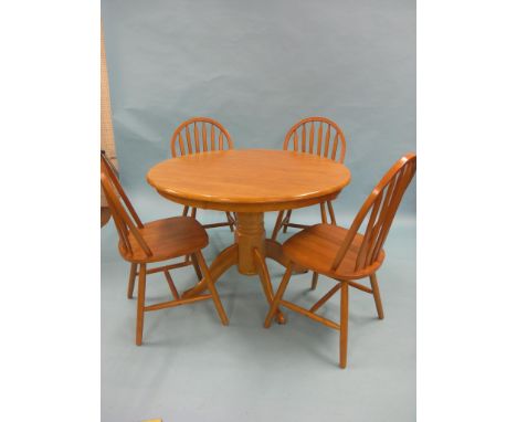 A modern light beech kitchen diner set, circular pedestal table, four stick-back chairs, clean 